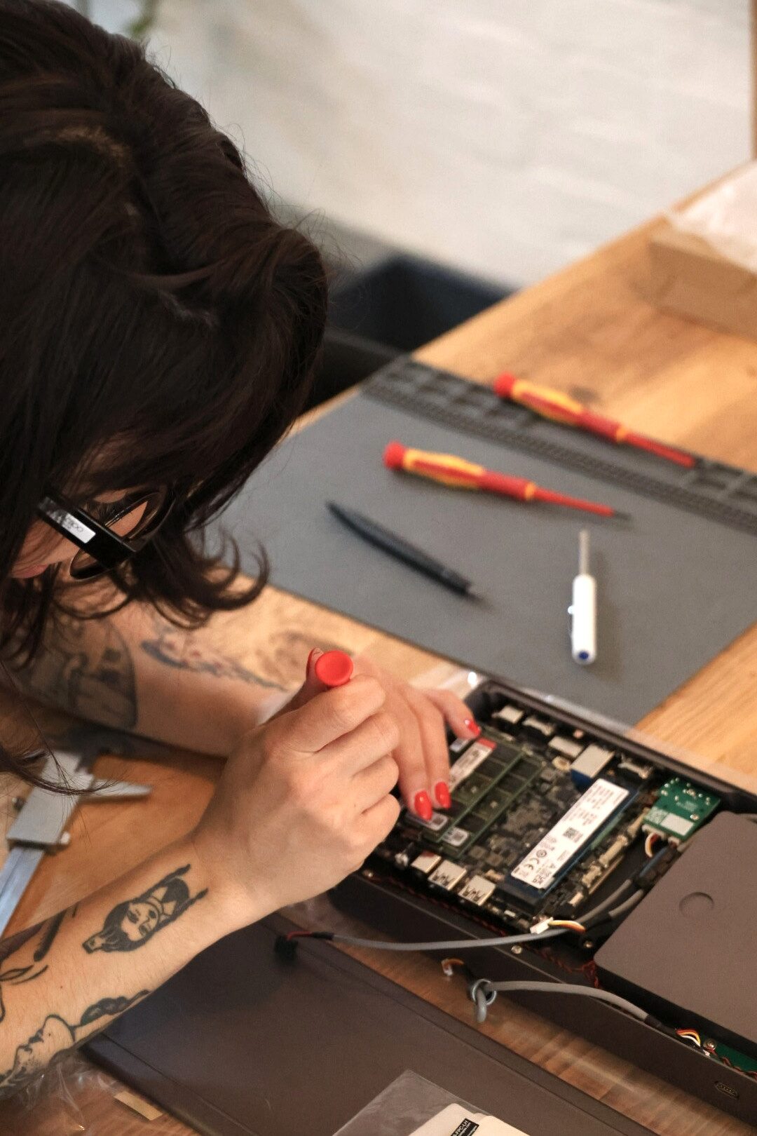 A Caligra team member assembling a c100 workstation